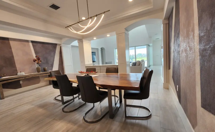 Open Dining Area with Live-Edge Table and Textured Accent Wall | PaperWorks Plus, Jupiter FL