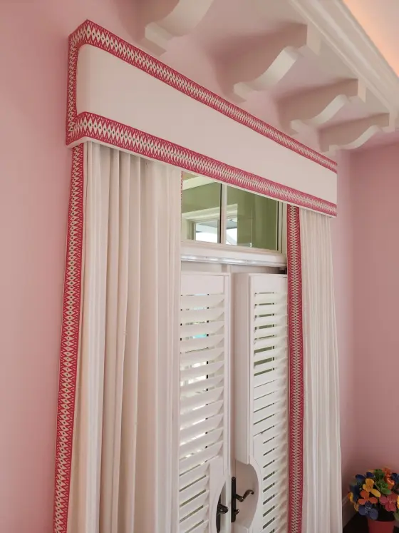 Custom Cornice with Contrast Trim and Drapery Panels over Shutters in a Pink Room | PaperWorks Plus, Jupiter FL