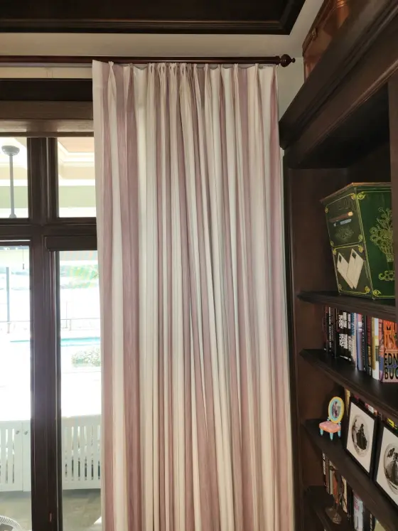 Custom Drapery Panel on Wood Hardware beside a Built-In Bookcase | PaperWorks Plus, Jupiter FL