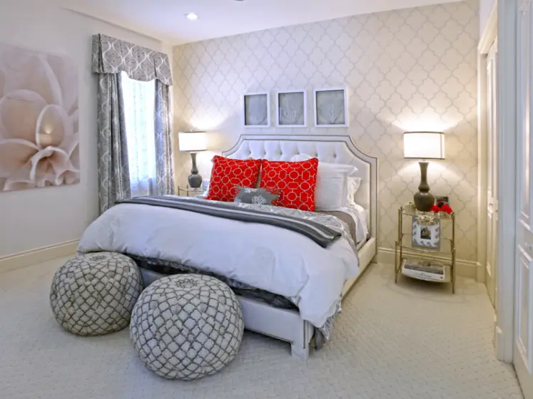 Custom Bedding with Red Accent Pillows and Patterned Poufs in a Guest Bedroom | PaperWorks Plus, Jupiter FL